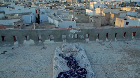 a dirty mattress on the roof of a house, a place where people spend the night without a home and without social security, lost people, victims of revolutions and coups d'etat