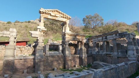 Panning view revealing the remains of corinthian style columns of Fountain of Trajan in Ephesus.