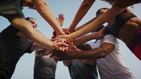 Young beautiful group of sportswomen standing shaking hands after after a successful workout. A team of athletes, men and women, stand in a circle and shake hands. Group of like-minded people. - Powered by Shutterstock - Get 15% off with code: PIKWIZARD15