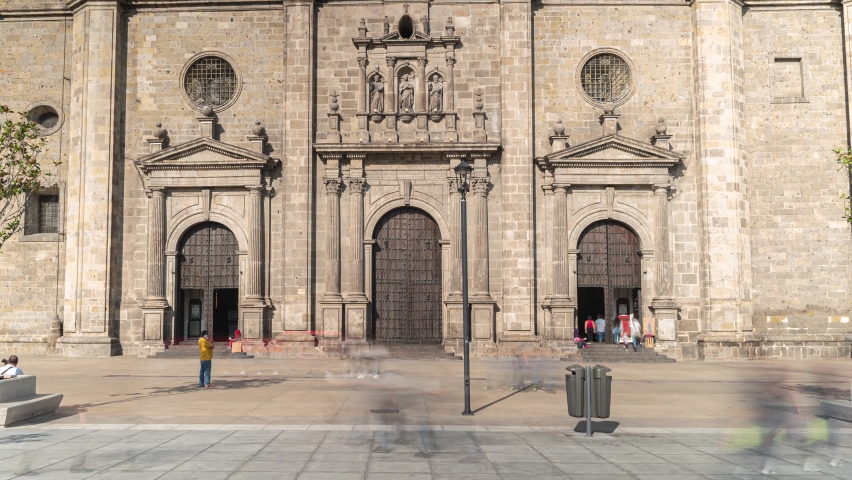 Guadalajara , Jalisco , Mexico - 07 01 2021: Wonderful time laps of the old cathedral of Guadalajara Jalisco Mexico and people passing fast at speed