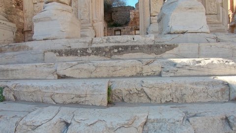 Upward tiling shot of tall Corinthian columns at the Library of Celsus in the ancient city of Ephesus. 