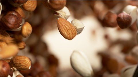 Super slow motion of flying nuts mix in rotating movement. Filmed on high speed cinema camera.