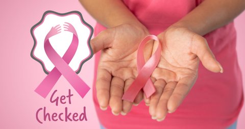 Animation of pink ribbon logo with breast cancer text over women hands. breast cancer positive awareness campaign concept digitally generated video.