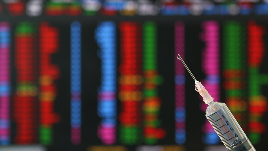 Syringe fill with covid-19 vaccine with stock exchange board background , concept vaccine can help economic recovery. - Powered by Shutterstock - Get 15% off with code: PIKWIZARD15