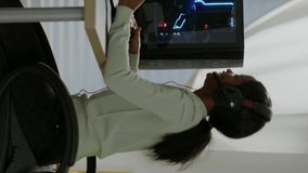 Vertical video: Winner black gamer sitting on gaming chair playing video games with wireless controller. Pro cyber man streaming online videogames for esport tournament on RGB powerful personal - Powered by Shutterstock - Get 15% off with code: PIKWIZARD15