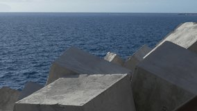 Ungraded: Breakwater of large concrete blocks on the atlantic coast of the Canary Islands. Ungraded H.264 from camera without re-encoding.