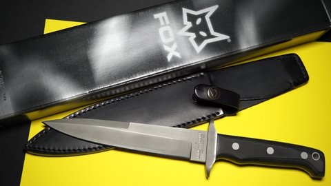 Rome, Italy - July 30, 2021, military knife of the Italian manufacturer FOX mod. Big Game 604, design by FOX Knives. 440C stainless steel, HRC 57-59, with sturdy black full grain leather sheath.