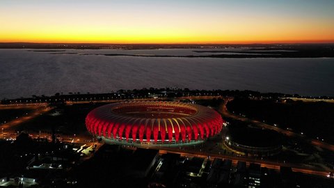 Porto Alegre, Rio Grande do Sul, Brazil - 07.27.2021 - Panorama sunset view of football stadium at downtown city of Porto Alegre, Brazil. Beira Rio soccer stadium at sunset time. Football arena field.