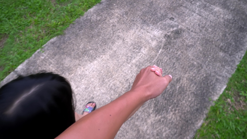 POV father hand hold little girl walk in garden