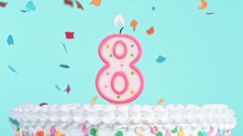 Birthday Cake With Burning Colorful Candle with Number 8 on Pastel Background. Falling confetti. Super Slow Motion, 
