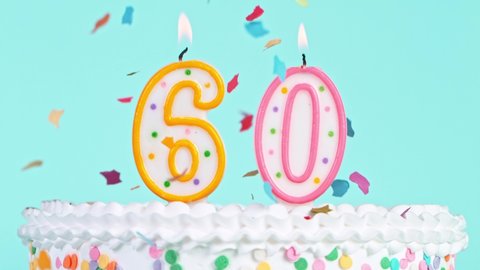Birthday Cake With Burning Colorful Candles with Number 60 on Pastel Background. Falling confetti. Super Slow Motion,