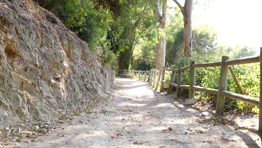 Mature Caucasian couple hiking on a dirt road in a public park