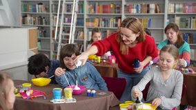 Positive female teacher squeezing shaving foam for slime into bowls of joyful kids with autism. Inclusive education for children with special needs - Powered by Shutterstock - Get 15% off with code: PIKWIZARD15