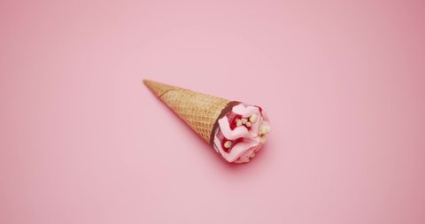 Close-up detail Top view, Ice cream cone strawberry Melting isolated on pink background.