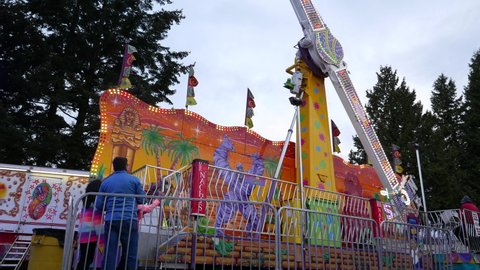COQUITLAM , British Columbia , Canada - 04 09 2017: Coquitlam, BC, Canada - April 09, 2017 : People having fun at the West Coast Amusements Carnival with 4k resolution