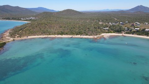 Panoramic View Of The Lush Forest In Hideaway Bay Town And Blackcurrant Island In Australian State Of Queensland. aerial