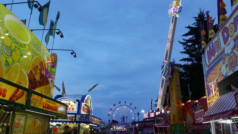 COQUITLAM , British Columbia , Canada - 04 09 2017: Coquitlam, BC, Canada - April 09, 2017 : Night shot of people having fun at the West Coast Amusements Carnival with 4k resolution