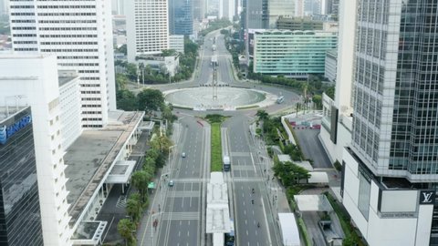 JAKARTA - Indonesia. July 23, 2021: Aerial view of quiet Hotel Indonesia Roundabout road in Jakarta city due to emergency public activity restriction (PPKM Darurat). Shot in 4k resolution