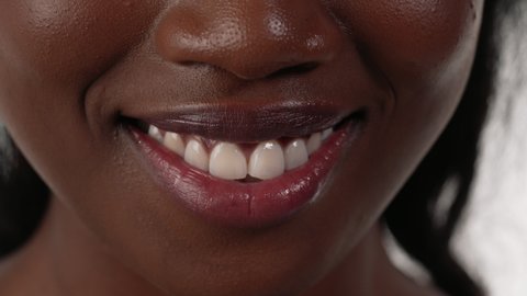 Close up of an african woman's mouth, pouting.