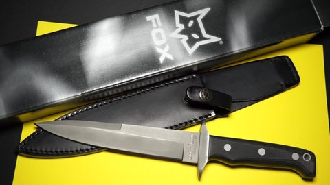 Rome, Italy - July 30, 2021, military knife of the Italian manufacturer FOX mod. Big Game 604, design by FOX Knives. 440C stainless steel, HRC 57-59, with sturdy black full grain leather sheath.