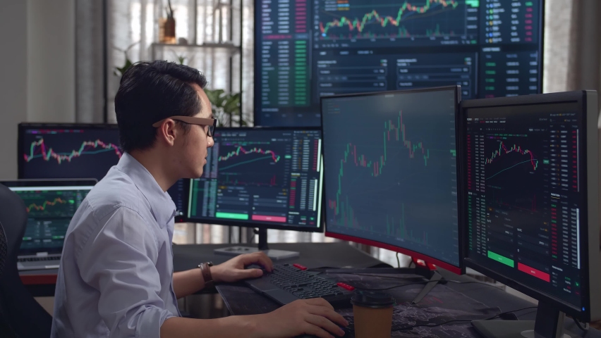 Asian Young Male Stock Market Broker Analysing Graphs On Multiple Computer Screens
 | Shutterstock HD Video #1076805764