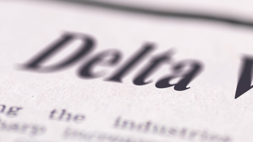 Footage of Delta variant written newspaper close up shot to the text.