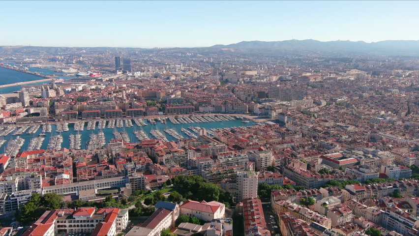 Marseille: Aerial view of city in France, Old Port of Marseille (Vieux-Port de Marseille), historic harbor used today as large marina, many yachts and boats - landscape panorama of Europe from above Royalty-Free Stock Footage #1076807036