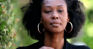 Thoughtful African woman thinking outside, undecided uncertain emotion