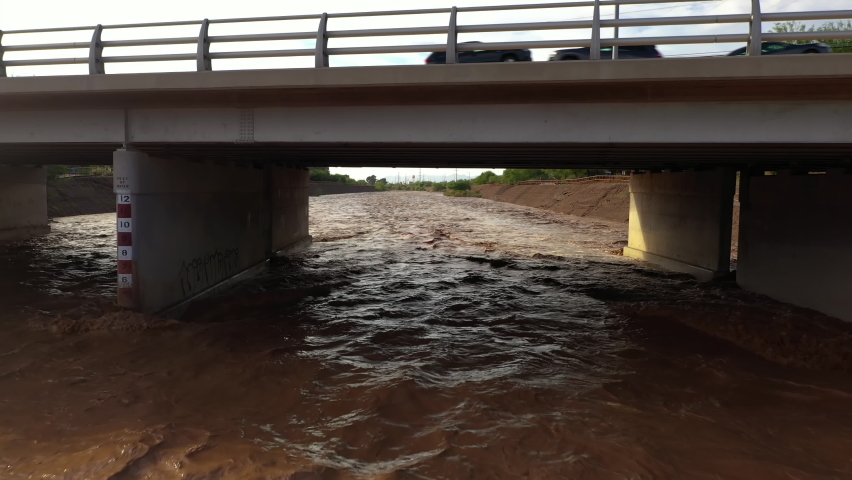 Raging River Under Road Bridge In Tucson, Arizona After The Heavy Monsoon Rain. drone sideways