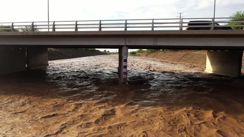 Water Measurement Scale Inundated In Raging River Under The Bridge. Santa Cruz River In Tucson, Arizona. dolly-in shot