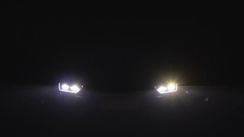 Close up of headlight turning on switching of car LED headlights in night. New modern car headlamp. Car Front Led Light with a Blurry Background