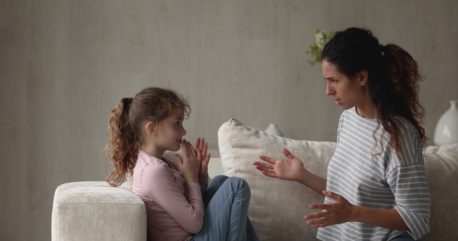 Irritated by bad naughty behavior angry young latin mother or nanny lecturing scolding stressed unhappy small kid girl, different generations gap, family relationship problems, crisis conflict. Royalty-Free Stock Footage #1076830976