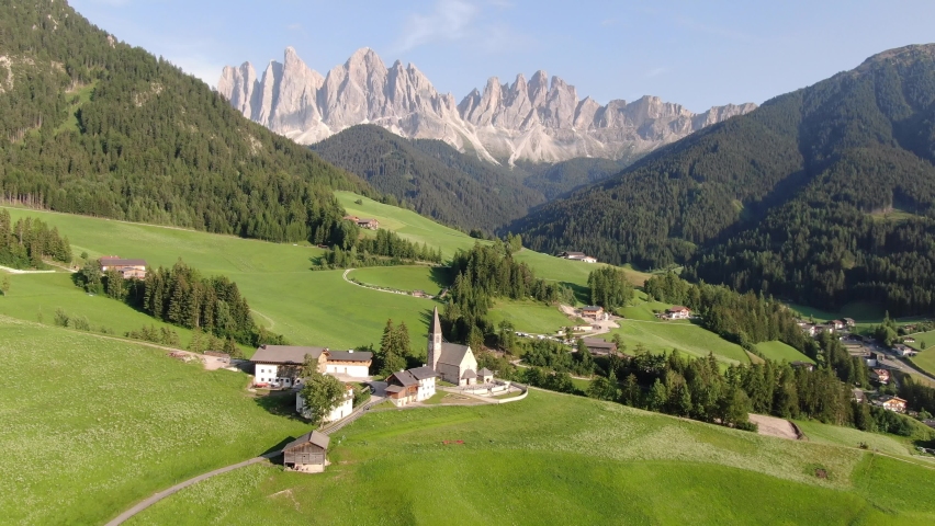 Flying over Santa Maddalena village (St Magdalena) in Dolomites mountains, Italy | Shutterstock HD Video #1076836952
