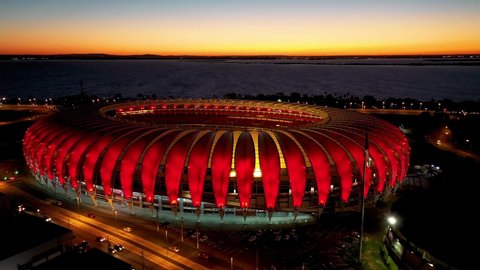 Porto Alegre, Rio Grande do Sul, Brazil - 07.29.2021 - Night panorama aerial view Football Field Stadium of Internacional Football Club. Night city. Colorful soccer stadium. Beira Rio football field.