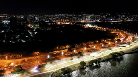 Porto Alegre, Rio Grande do Sul, Brazil - 07.29.2021 - Night panorama aerial view of Guaiba sidewalk of Porto Alegre, capital city of state of Rio Grande do Sul, Brazil. Guaiba River Edge at night.