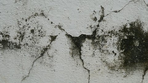 Old concrete wall background with large crack.Grey cement wall surface with large damage.