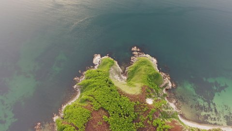View from a drone vertically down on the rocks of Cape Kuzmin in the Gulf of Vladimir during the day. The sky is clouded over. Primorsky Territory, Russia