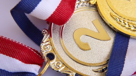 Top view of winner or champion gold silver bronze trophy medal rotating on white background. Victory first place of competition. Winning or success concept.