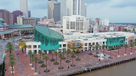 Aerial: Mississippi River waterfront and Audubon Aquarium of the Americas, New Orleans, Louisiana, USA. 24 June 2020