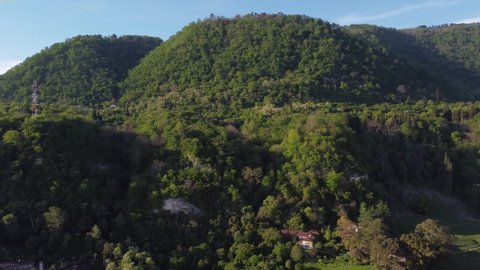 Aerial video from the drone. Beautiful mountain landscape on the Black Sea coast in Abkhazia. Lush forests and sunny weather in the south. The city of New Athos, Abkhazia.