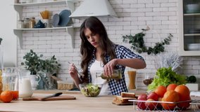 Woman pouring oil in vegetable salad. Female chef pouring olive oil in salad. Beautiful woman cooking salad in bowl. Woman dressing fresh salad with olive oil. Healthy breakfast. Vegan lifestyle - Powered by Shutterstock - Get 15% off with code: PIKWIZARD15