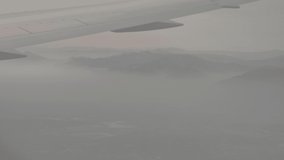 Plane View On Cloudy Mountains