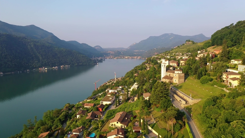 Aerial drone footage of the Vico Morcote old town with the Chiesa dei San Fedele church by lake Lugano in Canton Ticino in Switzerland. Shot with a rotation motion