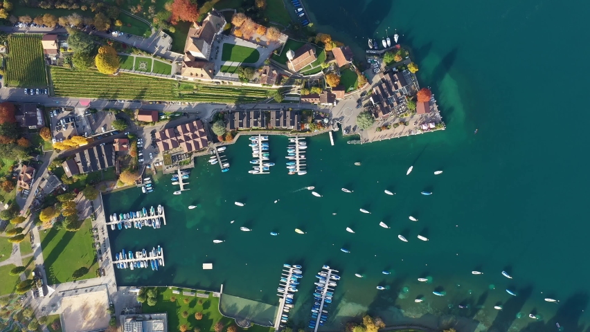 Aerial top drone footage of the Spiez old town and marina by lake Thun in Canton Bern in Switzerland