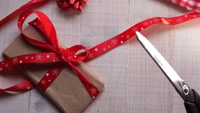 Wrapping gifts for Christmas red and white background overhead flat lay slider dolly close up shot - Powered by Shutterstock - Get 15% off with code: PIKWIZARD15
