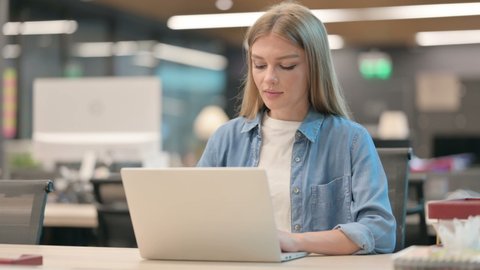 Woman Working on Laptop in Office 