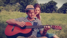 Animation of sweet over couple playing guitar. social media and communication concept digitally generated video.