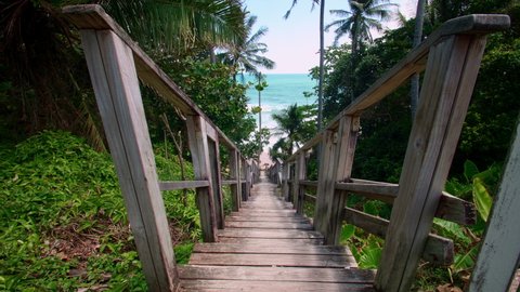 4K POV Wooden steps leading down to the beach. Wooden stairs down to the tropical beach. Phuket freedom beach Thailand. Summer day holiday vacation concept