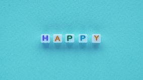 happy text optimism message cubes letters blue - Powered by Shutterstock - Get 15% off with code: PIKWIZARD15
