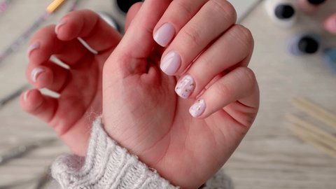 4k Closeup elegant pastel natural modern design manicure. Female hands. Gel nails. Nude manicure. Beige color. Skin care. Beauty. Nail care